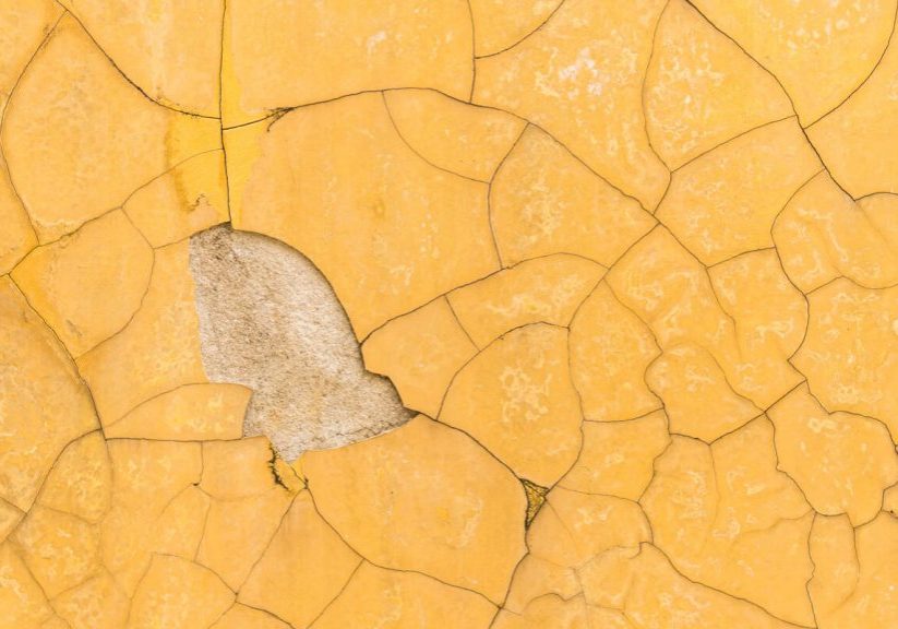 Peeling and cracked exterior house paint showing signs it’s time to repaint your home’s exterior.